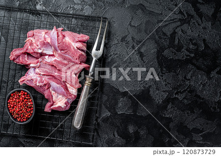 Raw Turkey sliced fillet meat ready for cooking. Black background. Top view. Space for text Raw Turkey sliced fillet meat ready for cooking. Black background. Top view. Space for text 120873729