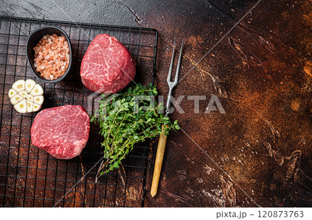 Raw Fillet Mignon Beef steaks, Dry aged tenderloin meat. Dark background. Top view. Space for text 120873763