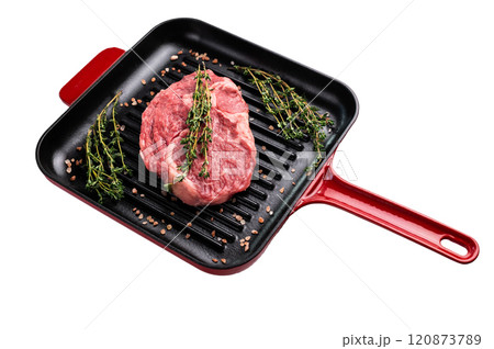 Raw Rib eye steak in a skillet, marbled prime beef meat isolated on white background 120873789