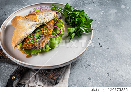Balik Ekmek Turkish fish sandwich with grilled mackerel fillet in a bun. Gray background. Top view. Copy space Balik Ekmek Turkish fish sandwich with grilled mackerel fillet in a bun. Gray background. Top view. Copy space 120873883