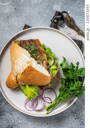 Balik Ekmek Turkish fish sandwich with grilled mackerel fillet in a bun. Gray background. Top view 120873893