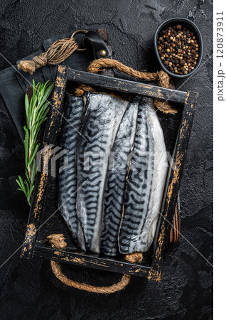Ready for cooking sliced raw mackerel fillet fish in a wooden box with herbs. Black background. Top view Ready for cooking sliced raw mackerel fillet fish in a wooden box with herbs. Black background. Top view 120873911