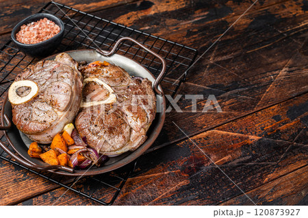 Veal shank stew Osso Buco, italian ossobuco meat steak. Wooden background. Top view. Copy space Veal shank stew Osso Buco, italian ossobuco meat steak. Wooden background. Top view. Copy space 120873927