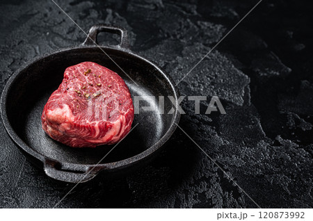 Fillet Mignon prime beef steak, raw dry aged marble meat with herbs and spices ready for cooking. Black background. Top view. Space for text Fillet Mignon prime beef steak, raw dry aged marble meat with herbs and spices ready for cooking. Black background. Top view. Space for text 120873992