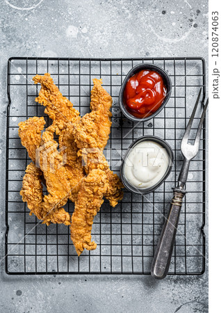 Dip fried Chicken Steak Fingers strips with sauces. Gray background. Top view Dip fried Chicken Steak Fingers strips with sauces. Gray background. Top view 120874063