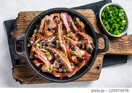 Fried spicy pork pig ears served in a frying pan. white background. Top view Fried spicy pork pig ears served in a frying pan. white background. Top view 120874076