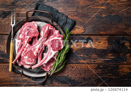 Raw lamb mutton chop steaks, fresh meat cutlets on butcher table. Black background. Top view. Copy space 120874114