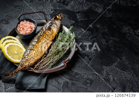 Baked Mackerel Scomber fish in steel tray with thyme and lemon. Black background. Top view. Copy space 120874139