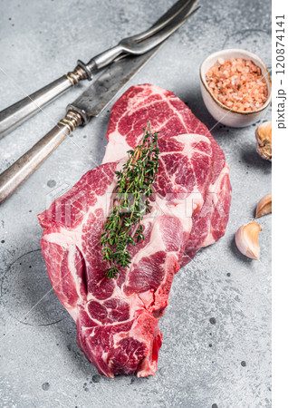Raw Pork steaks, fresh meat on butcher table. Gray background. Top view 120874141