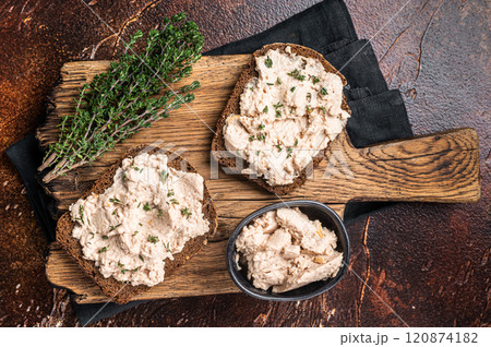 Cod Liver open Sandwich on wooden board. Dark background. Top view 120874182