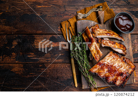 Grilled pork Baby Back spare ribs on a wooden board. Wooden background. Top view. Copy space Grilled pork Baby Back spare ribs on a wooden board. Wooden background. Top view. Copy space 120874212
