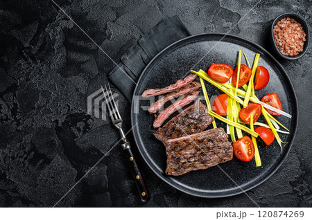 Grilled arrachera Skirt steak with garnish. Black background. Top view. Copy space 120874269