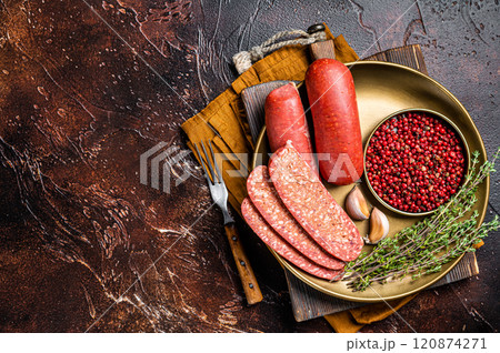 Sliced halal Sucuk beef meat sausage. Dark background. Top view. Copy space 120874271