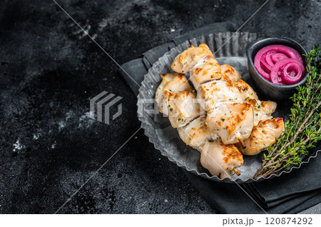 BBQ chicken shish kebab skewers, Shashlik with onion and spices. Black background. Top view. Copy space BBQ chicken shish kebab skewers, Shashlik with onion and spices. Black background. Top view. Copy space 120874292