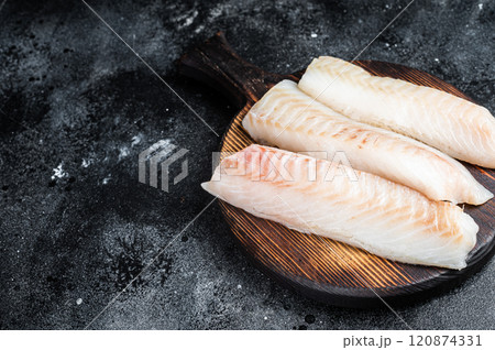 Fillets of codfish, raw cod fish meat. Black background. Top view. Copy space 120874331