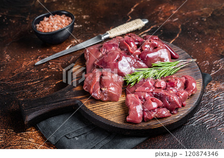 Sliced Raw chicken liver, fresh fowl offals on wooden board. Dark background. Top view Sliced Raw chicken liver, fresh fowl offals on wooden board. Dark background. Top view 120874346