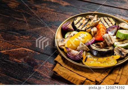 Various grilled Vegetables, bell pepper, zucchini, eggplant, onion and tomato. Wooden background. Top view. Copy space 120874392