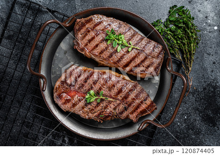 Grilled Top Blade or flat iron beef meat steaks. Black background. Top View 120874405