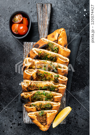 Sliced Turkish flatbread pide, Turkish pizza. Black background. Top view Sliced Turkish flatbread pide, Turkish pizza. Black background. Top view 120874427