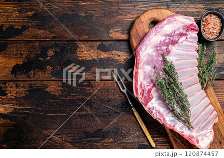Raw lamb mutton ribs with herbs on wooden board. Wooden background. Top view. Copy space Raw lamb mutton ribs with herbs on wooden board. Wooden background. Top view. Copy space 120874457