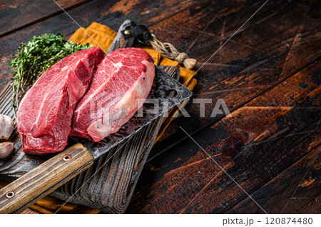 Dry aged Raw top blade beef meat steaks. Dark background. Top View. Copy space 120874480