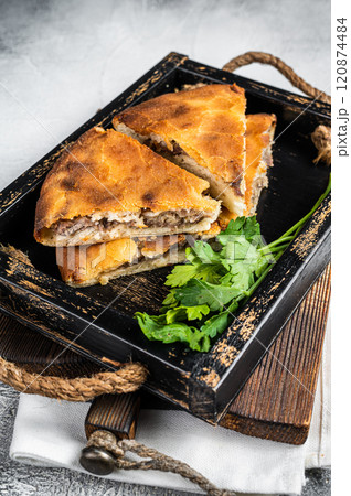 National traditional Caucasian cuisine Ossetian pie with beef meat. White background. Top view 120874484