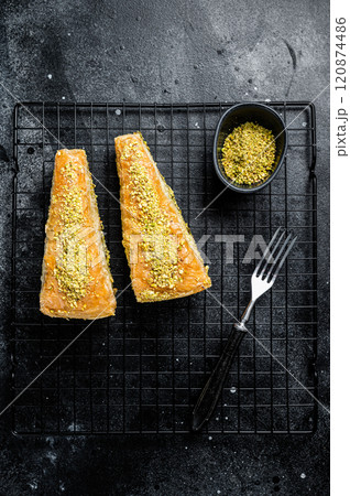 Turkish delights Havuc Dilim Baklava with pistachio and honey. Black background. Top view 120874486