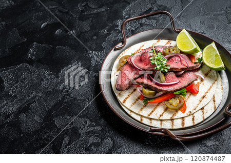 Carne Asada Tacos with grilled steak, green sauce, jalapenos and onion, Mexican food. Black background. top view. copy space 120874487