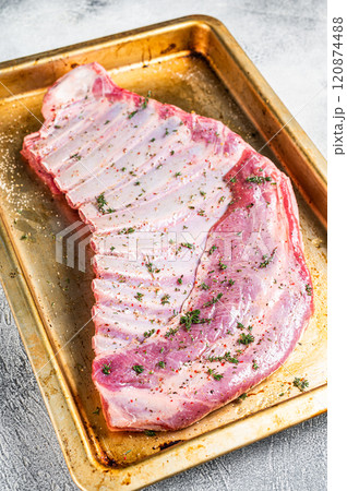 Marinated lamb mutton ribs with herbs and thyme in baking dish. White background. Top view 120874488