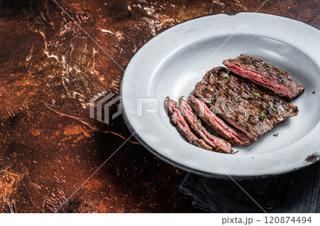 Homemade Cooked Skirt steak on a grill. Dark background. Top view. Copy space Homemade Cooked Skirt steak on a grill. Dark background. Top view. Copy space 120874494
