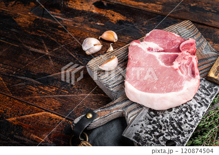 Butcher cutting board with Raw T-bone pork chop meat steak. Wooden background. Top view. Copy space 120874504