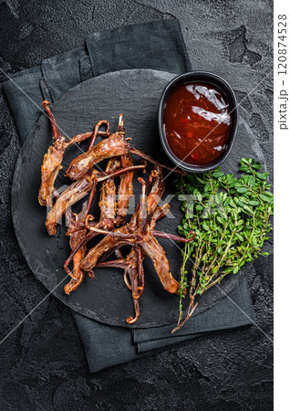 Cooked Spicy fried duck tongue. Black background. Top view 120874528