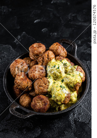 Skillet with Swedish beef Meatballs with Cream Sauce. Black background. Top view 120874576