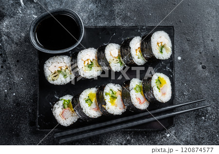 Korean rice roll Kimbap or gimbap, Korean sushi. Black background. Top view Korean rice roll Kimbap or gimbap, Korean sushi. Black background. Top view 120874577