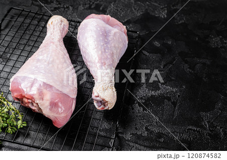 Raw turkey legs on a butcher table. Black background. Top view. Copy space 120874582