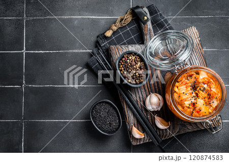 Homemade kimchi in a glass jar, traditional Korean cuisine. Black background. Top view. Copy space 120874583