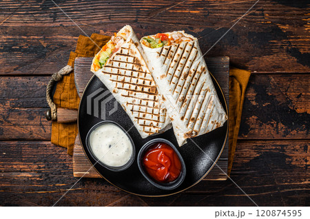 Shawarma, Shaurma chicken roll with vegetable salad. Wooden background. Top view 120874595