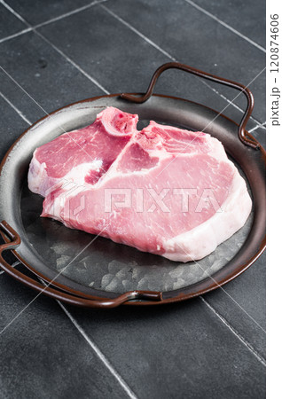 Raw pork t bone chop meat steak. Black background. Top view 120874606