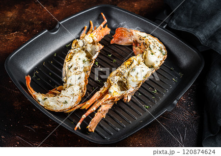 Delicious grilled and sliced Spiny lobster or sea crayfish. Dark background. Top view 120874624