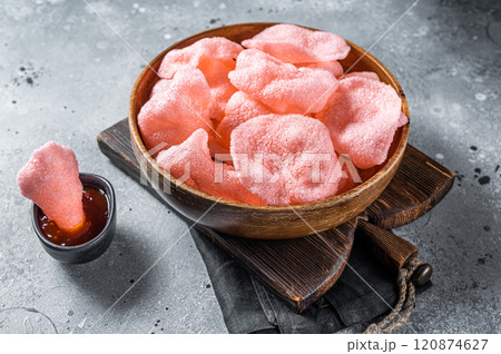 Crunchy kerupuk prawn shrimp crackers, chips. Gray background. Top view Crunchy kerupuk prawn shrimp crackers, chips. Gray background. Top view 120874627