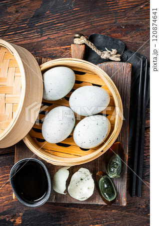 Black Century eggs, preserved duck egg, Chinese cuisine. Wooden background. Top view Black Century eggs, preserved duck egg, Chinese cuisine. Wooden background. Top view 120874641