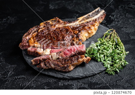 Roasted Tomahawk or cowboy with bone beef meat steak. Black background. Top view 120874670