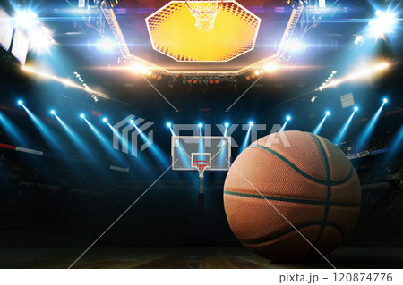 Basketball on the floor. Modern Basketball Arena with Rings with Spotlights, Creative Idea. Tournament and Win. Basketball game with full hall of fans on dark background. Basketball Championship. Basketball on the floor. Modern Basketball Arena with Rings with Spotlights, Creative Idea. Tournament and Win. Basketball game with full hall of fans on dark background. Basketball Championship. 120874776