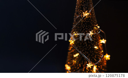 Magical Christmas tree with yellow lights stars on a dark background. New Year, holiday card. Free space for design and text. Winter wallpaper Magical Christmas tree with yellow lights stars on a dark background. New Year, holiday card. Free space for design and text. Winter wallpaper 120875178