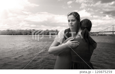 Insincere smile of a hugging girl Insincere smile of a hugging girl 120875259