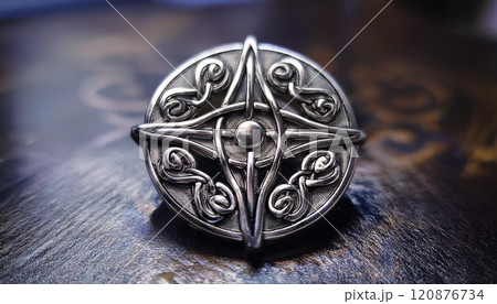 A silver and black metal pin with a design of a cross and a star 120876734