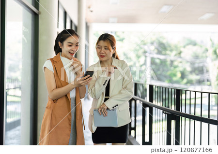 Confident Businesswomen Collaborating and Consulting in a Modern Office Environment for Strategic Planning and Decision Making 120877166