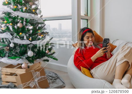 Happy woman in red sweater call and chat on the phone to merry her friends and family in Christmas holiday. Happy woman in red sweater call and chat on the phone to merry her friends and family in Christmas holiday. 120878500