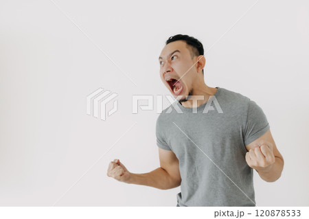 Angry and furious shouting face of man in grey t-shirt isolate on white. Angry and furious shouting face of man in grey t-shirt isolate on white. 120878533