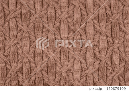 Demonstrating the colors of 2025 - Mocha Mousse. Knitted brown background. Large knitted fabric with a pattern. Close-up of a knitted blanket. Color concept. Demonstrating the colors of 2025 - Mocha Mousse. Knitted brown background. Large knitted fabric with a pattern. Close-up of a knitted blanket. Color concept. 120879109